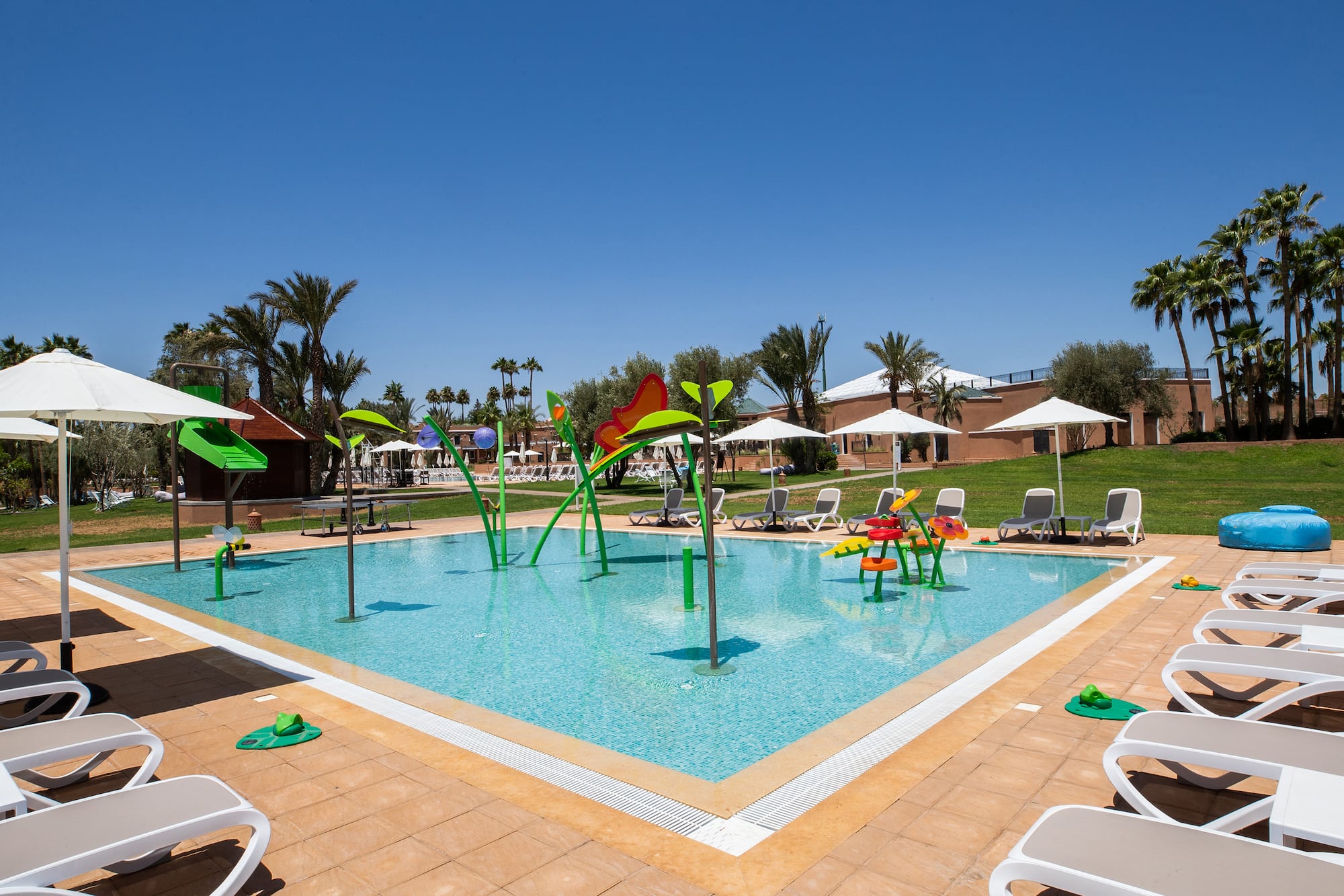 a pool with chairs and umbrellas