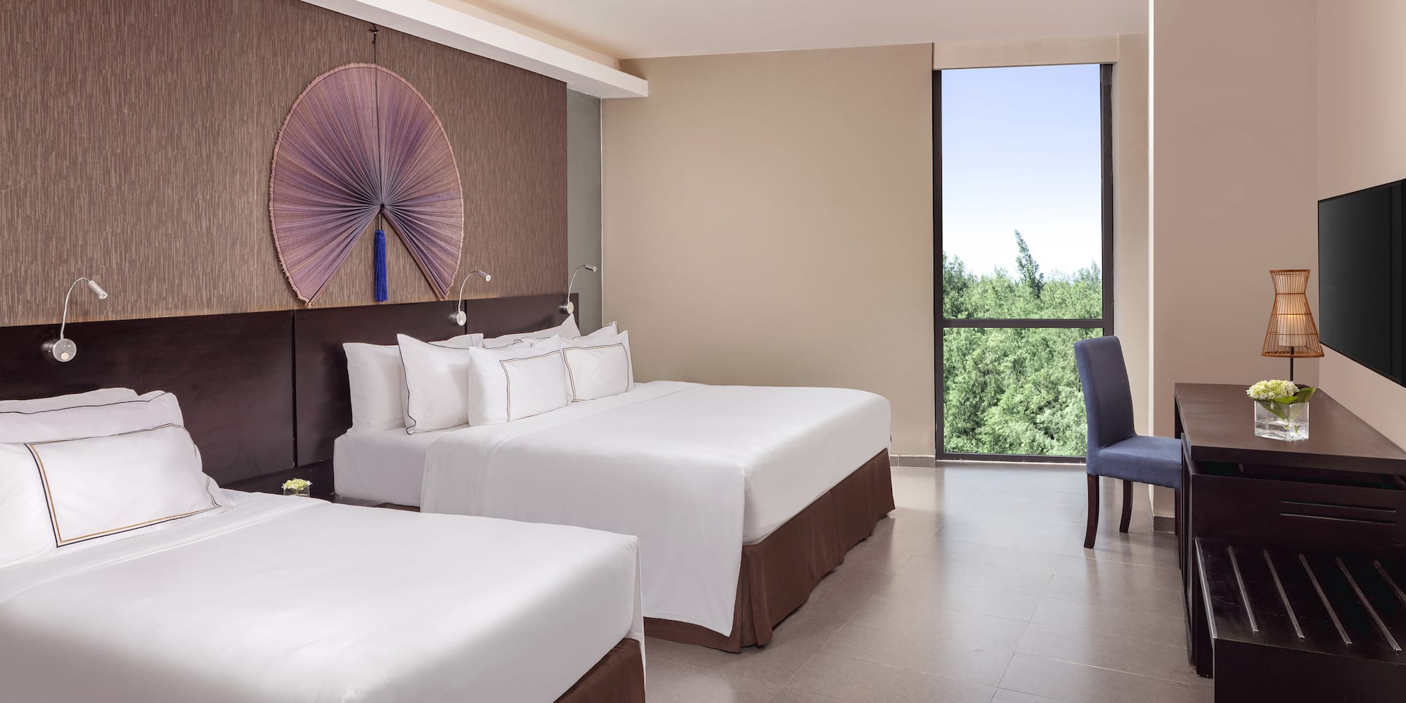 a room with two beds and a blue chair