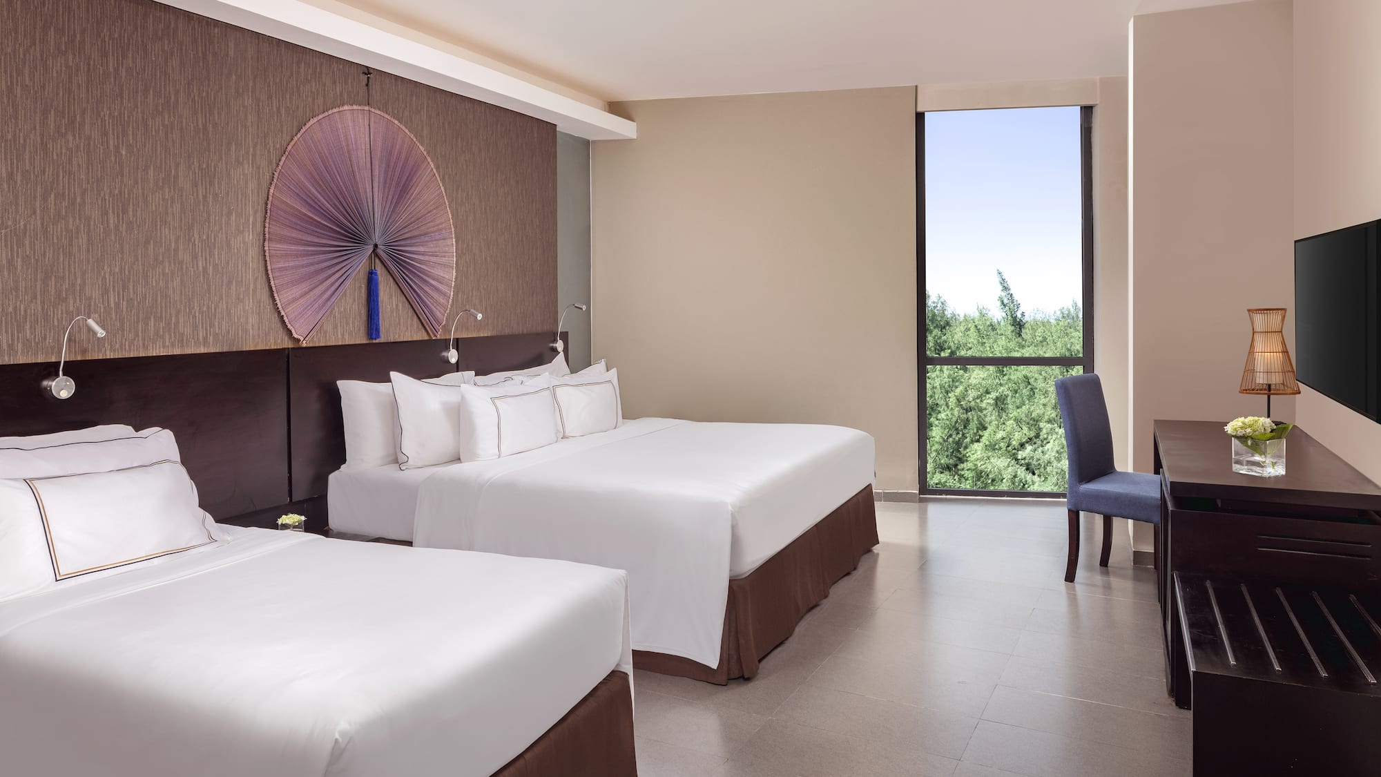 a room with two beds and a blue chair