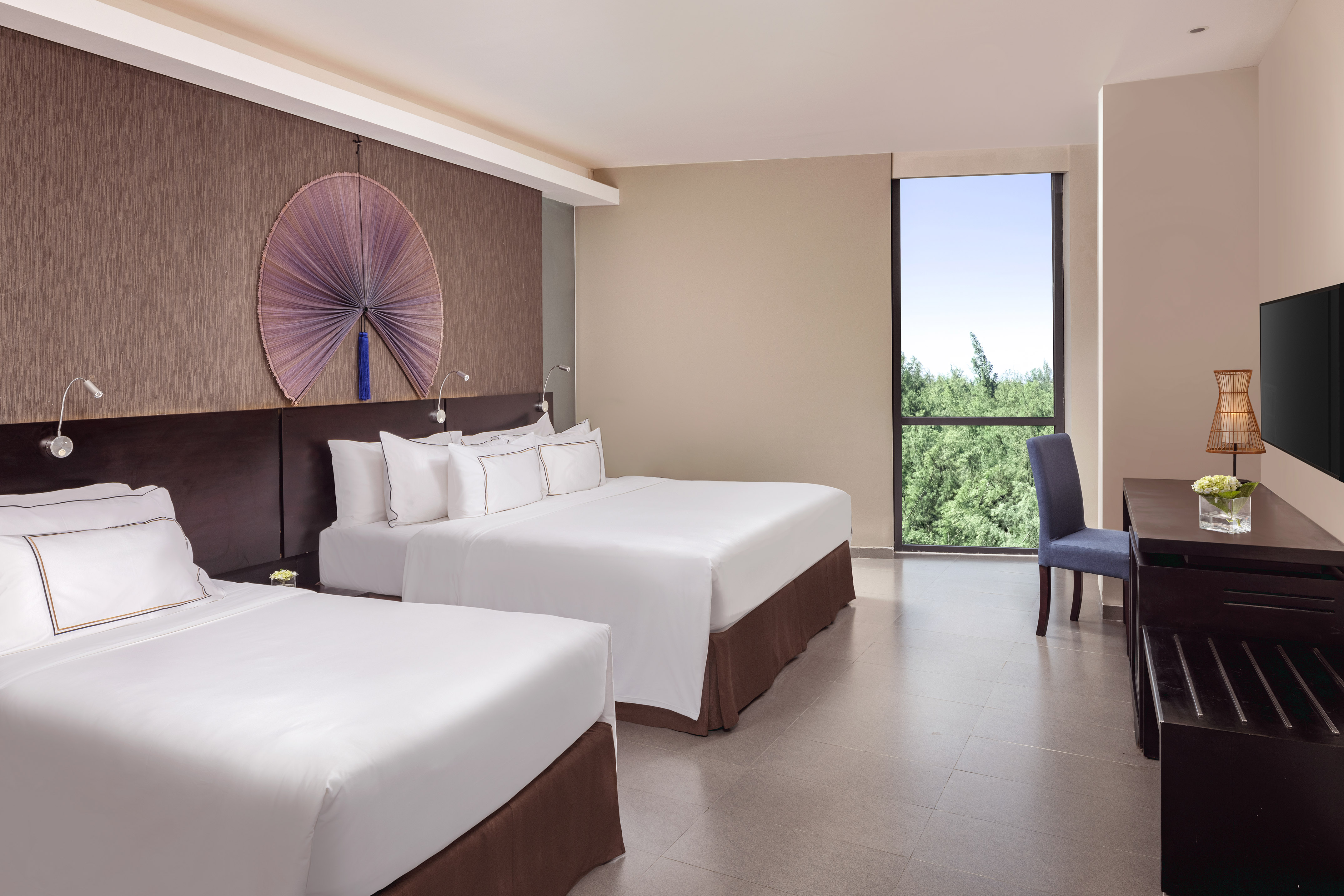 a room with two beds and a blue chair