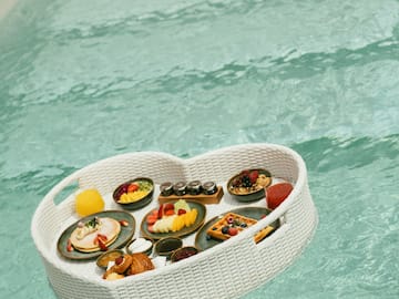 a basket of food floating in water