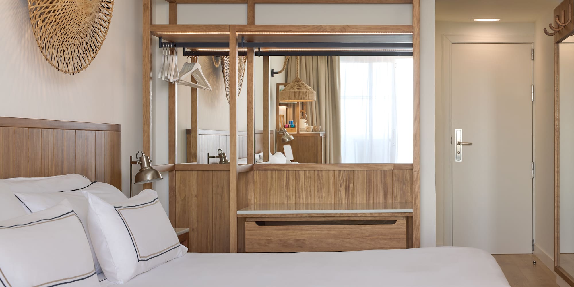 a bedroom with a mirror and a bed