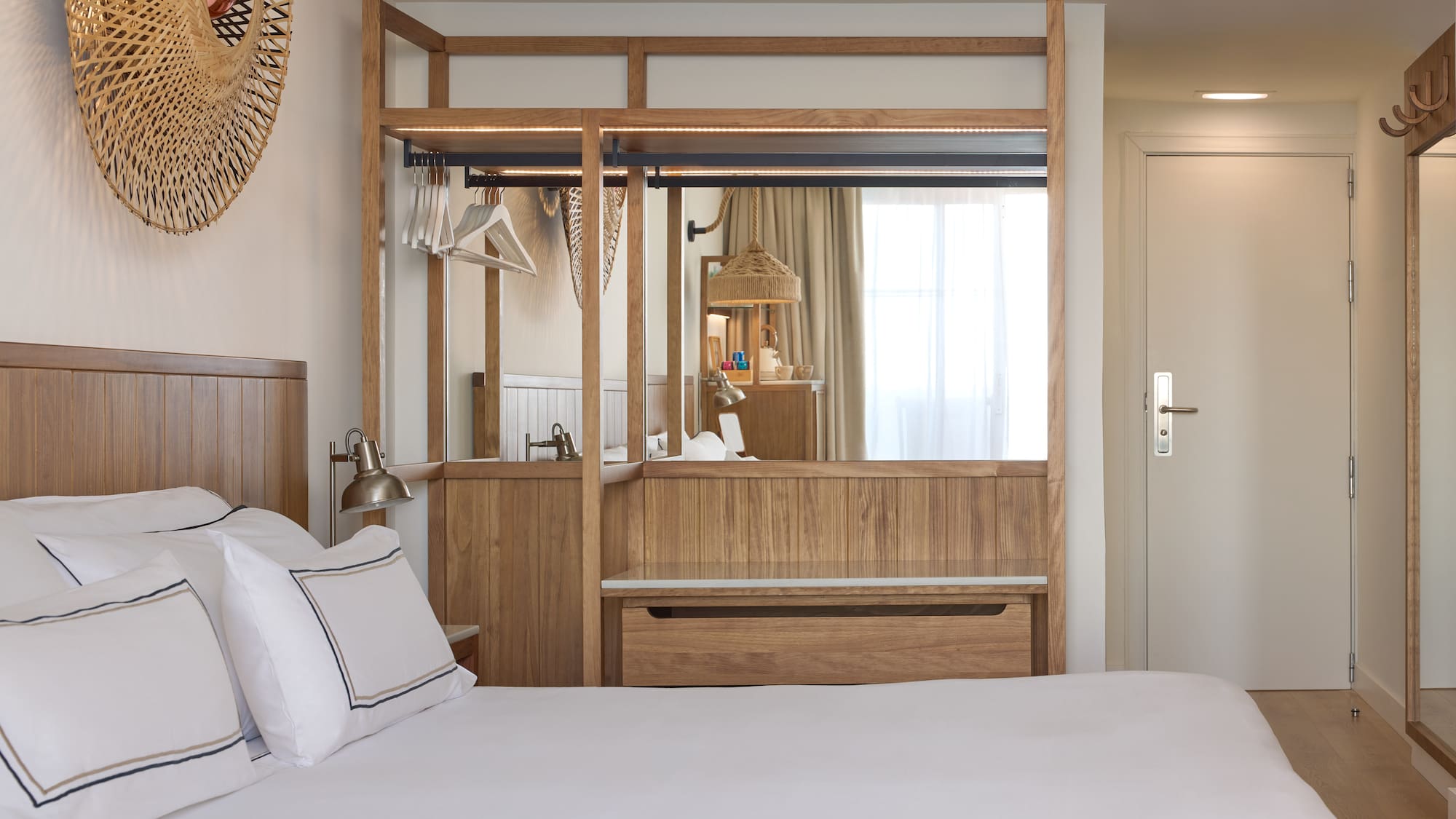 a bedroom with a mirror and a bed