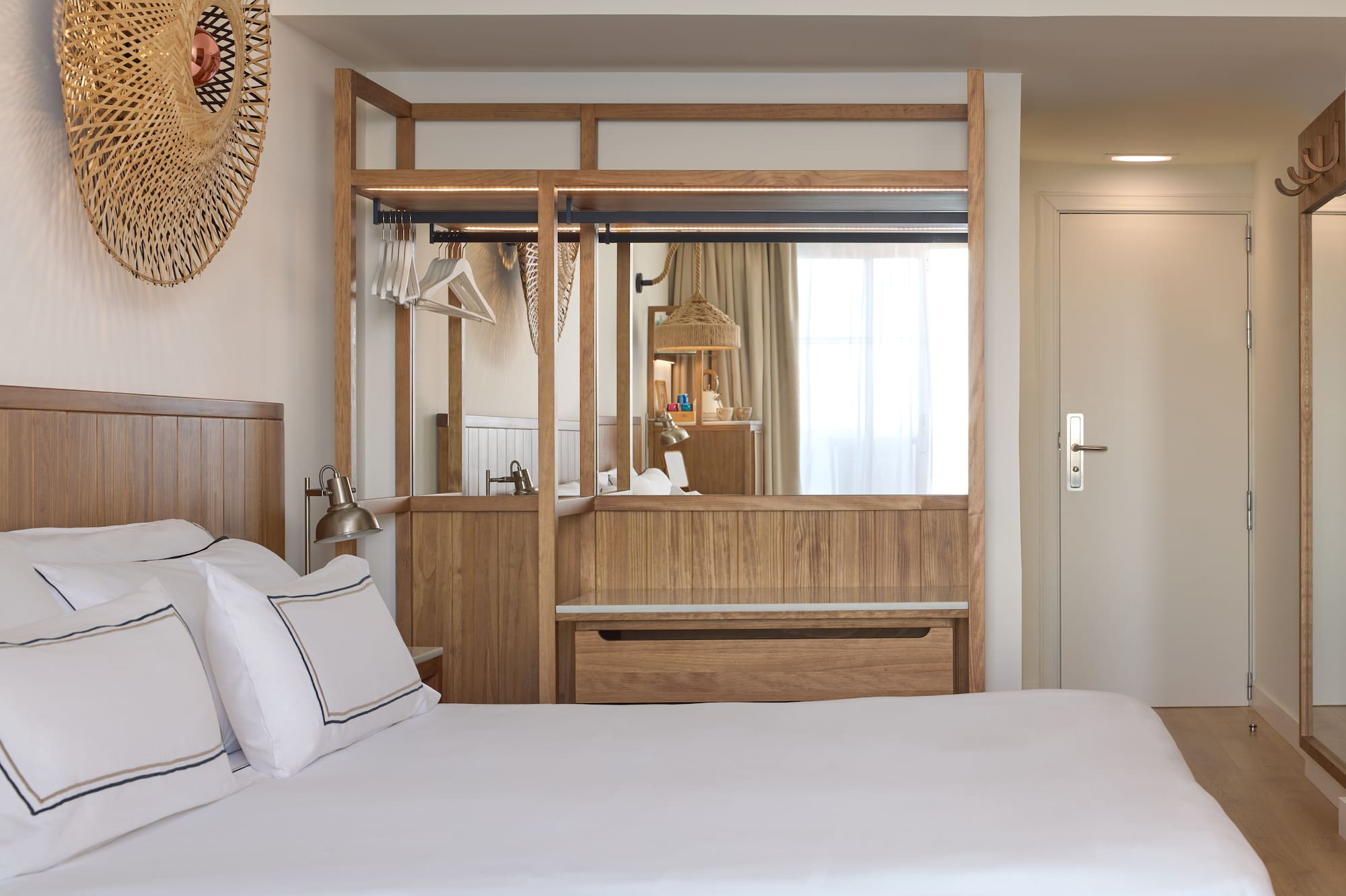 a bedroom with a mirror and a bed