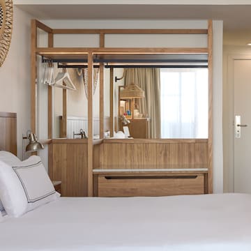 a bedroom with a mirror and a bed