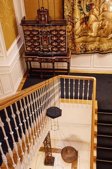a staircase with a cabinet and a carpet