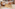 Hotel reception with wooden desk, staff, colorful mural, modern interior design.