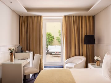 a room with a bed and a desk and chair
