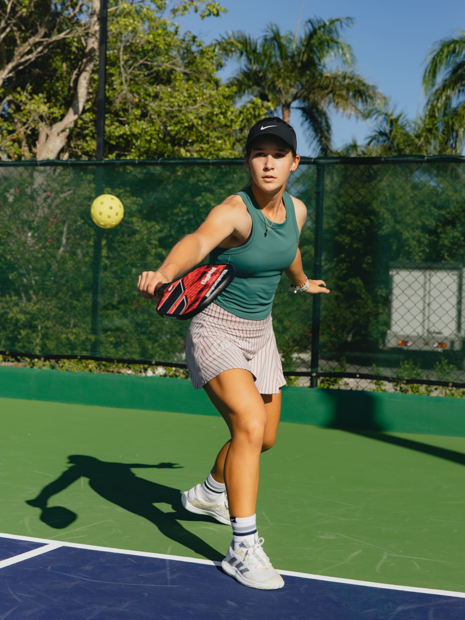 a woman hitting a ball with a racket