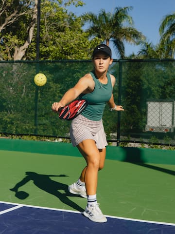 a woman hitting a ball with a racket