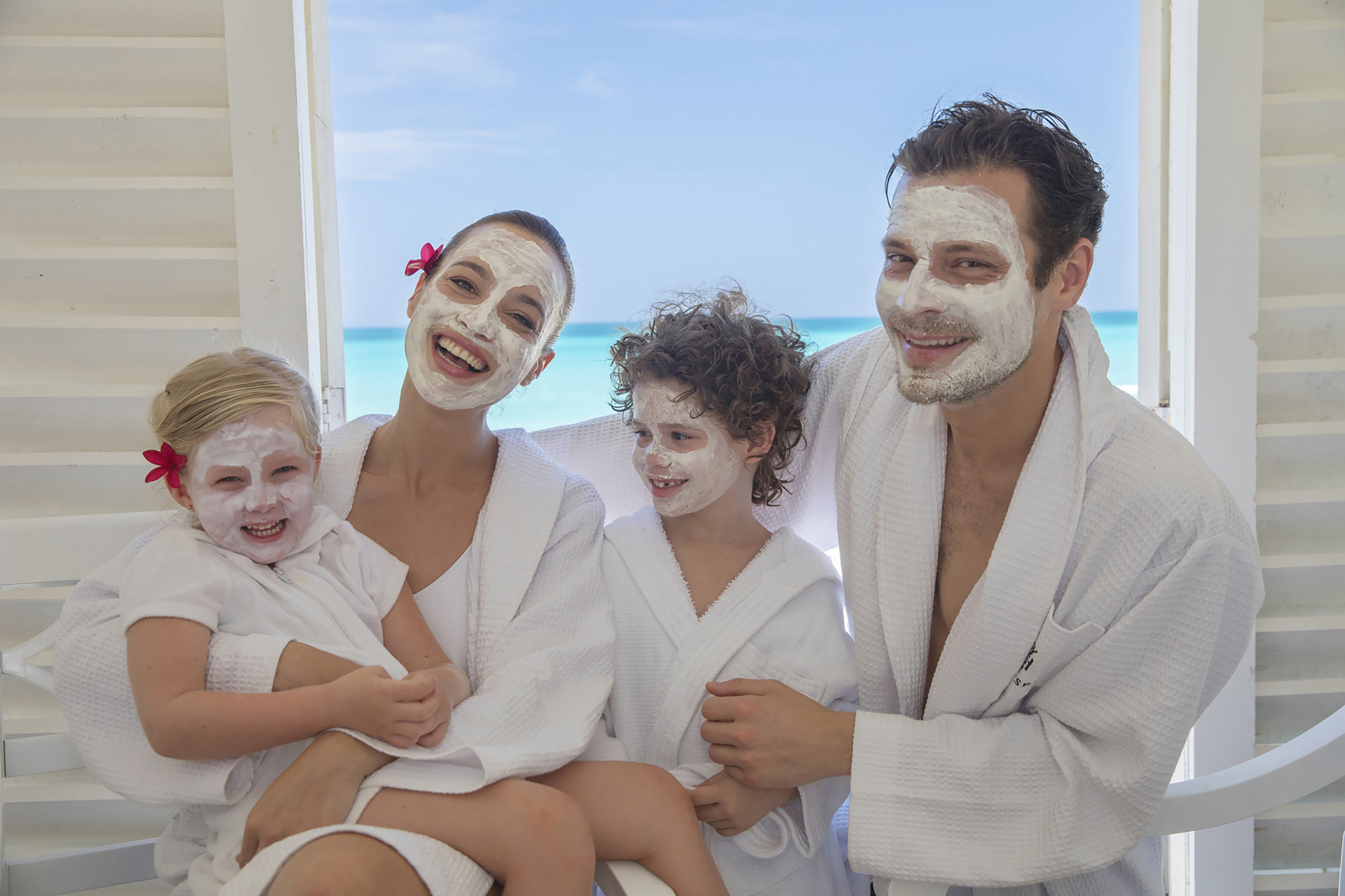 a group of people with white facial masks
