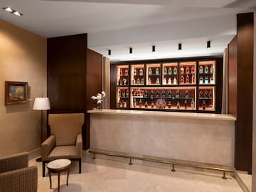 a bar with shelves of liquor bottles