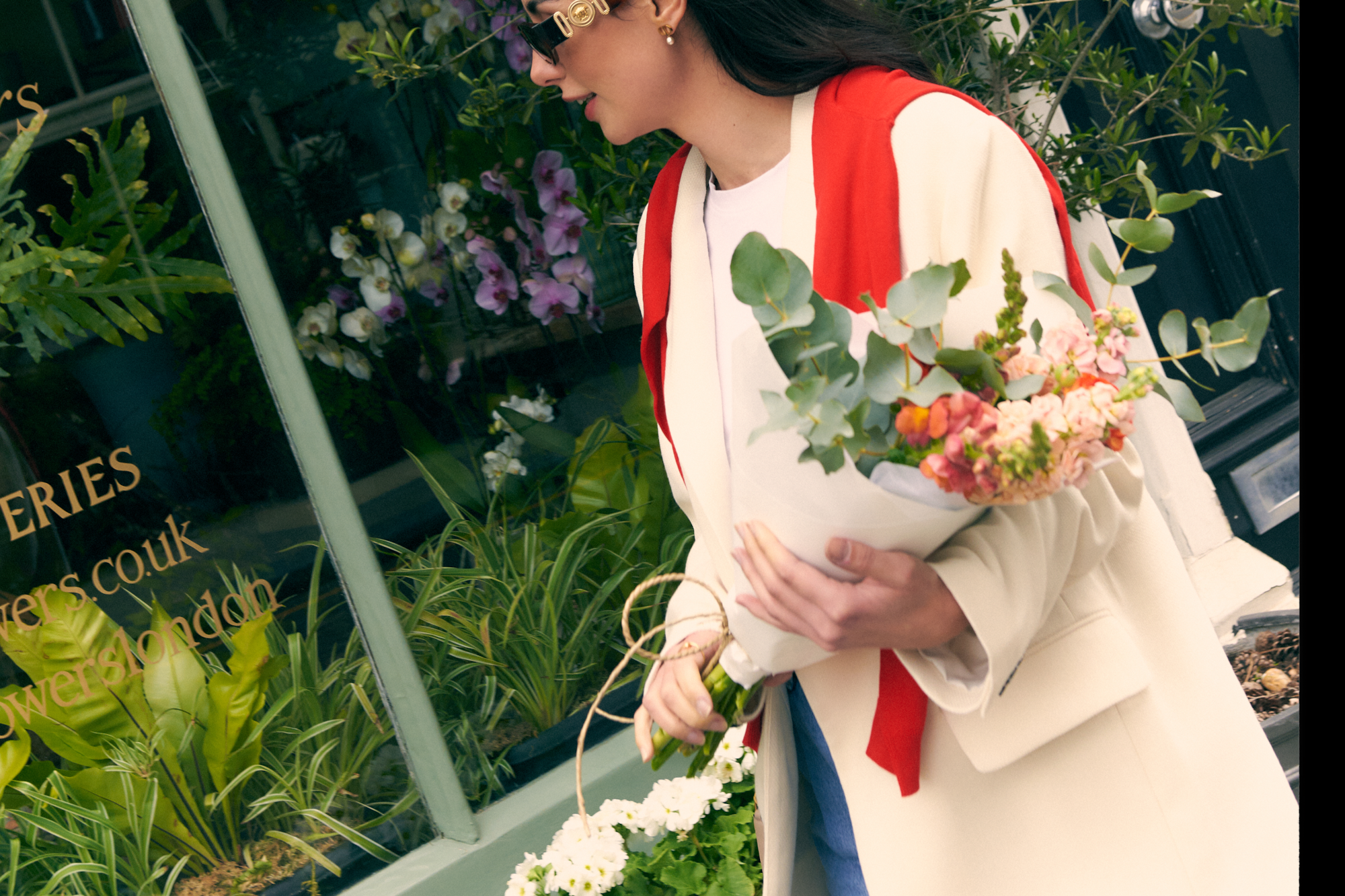 a woman holding a basket of flowers