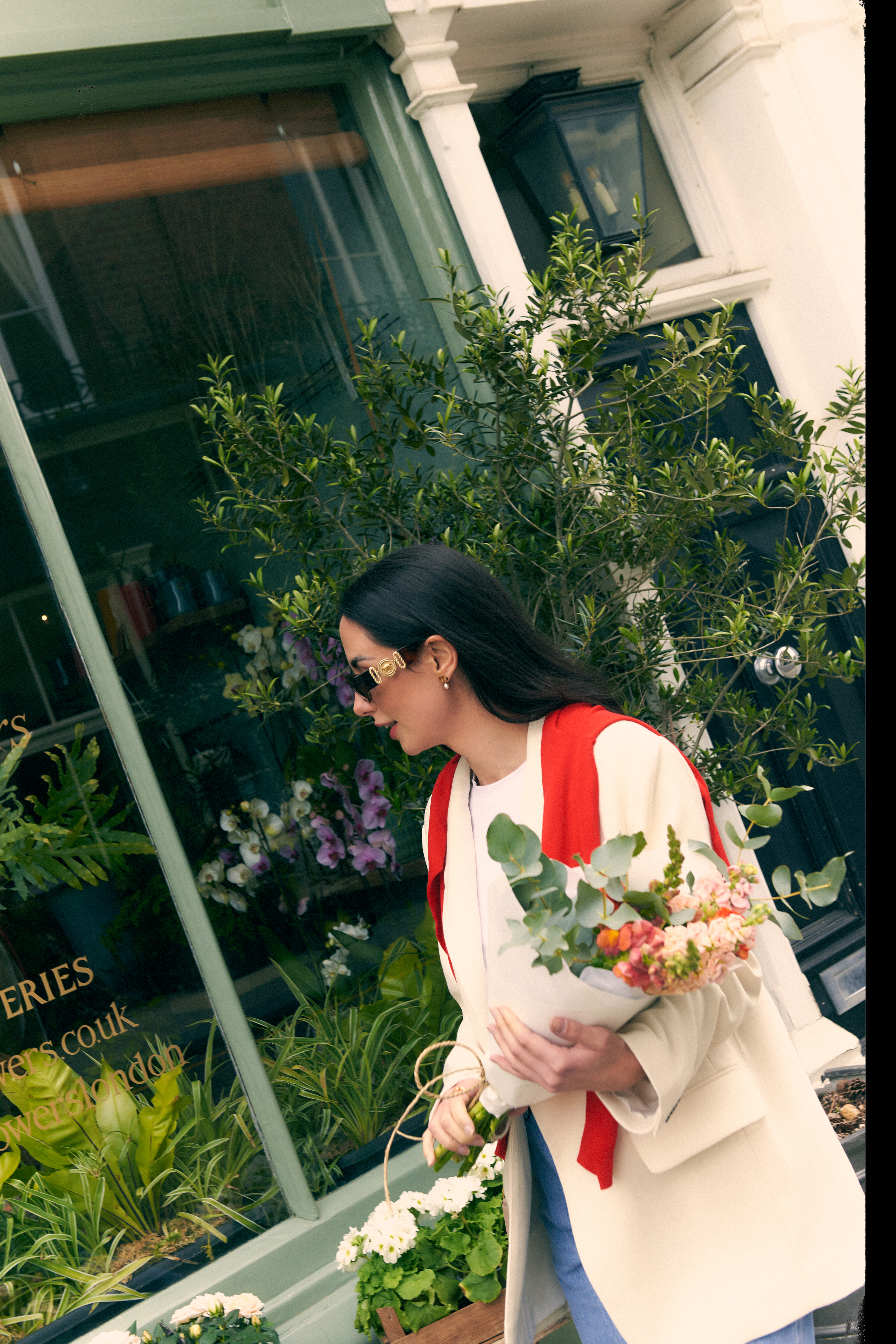 a woman holding a basket of flowers