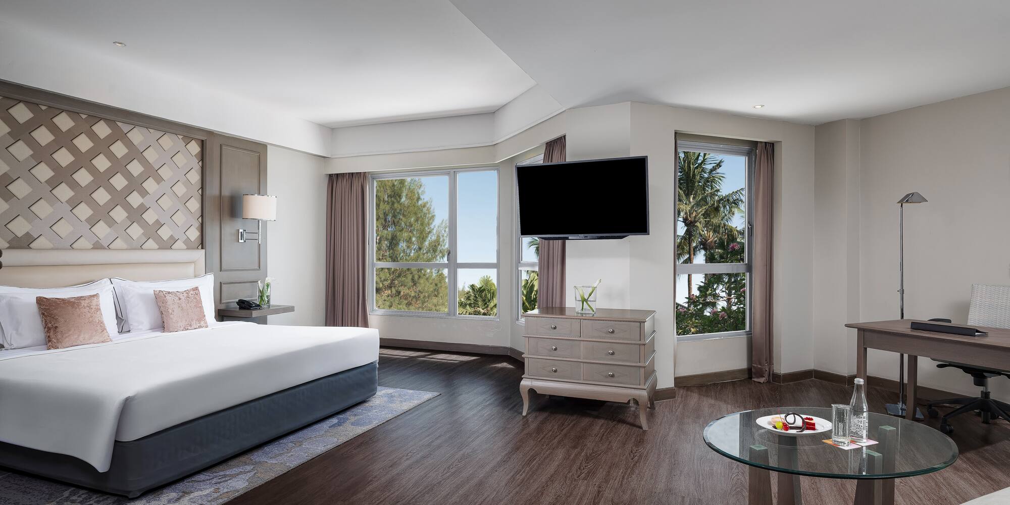 a room with a bed and a television