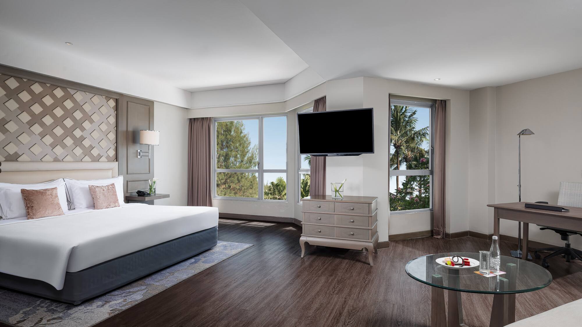 a room with a bed and a television