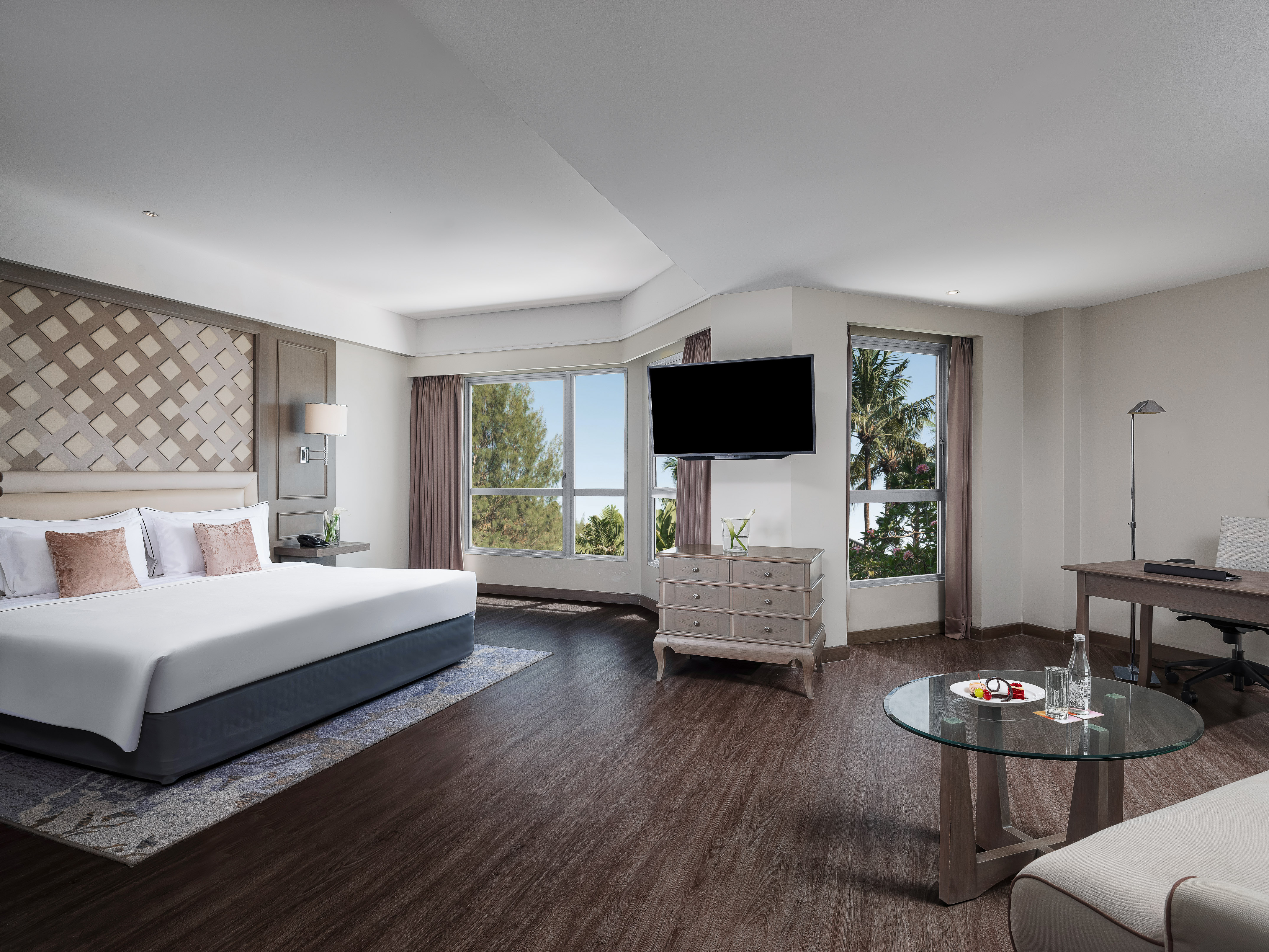 a room with a bed and a television