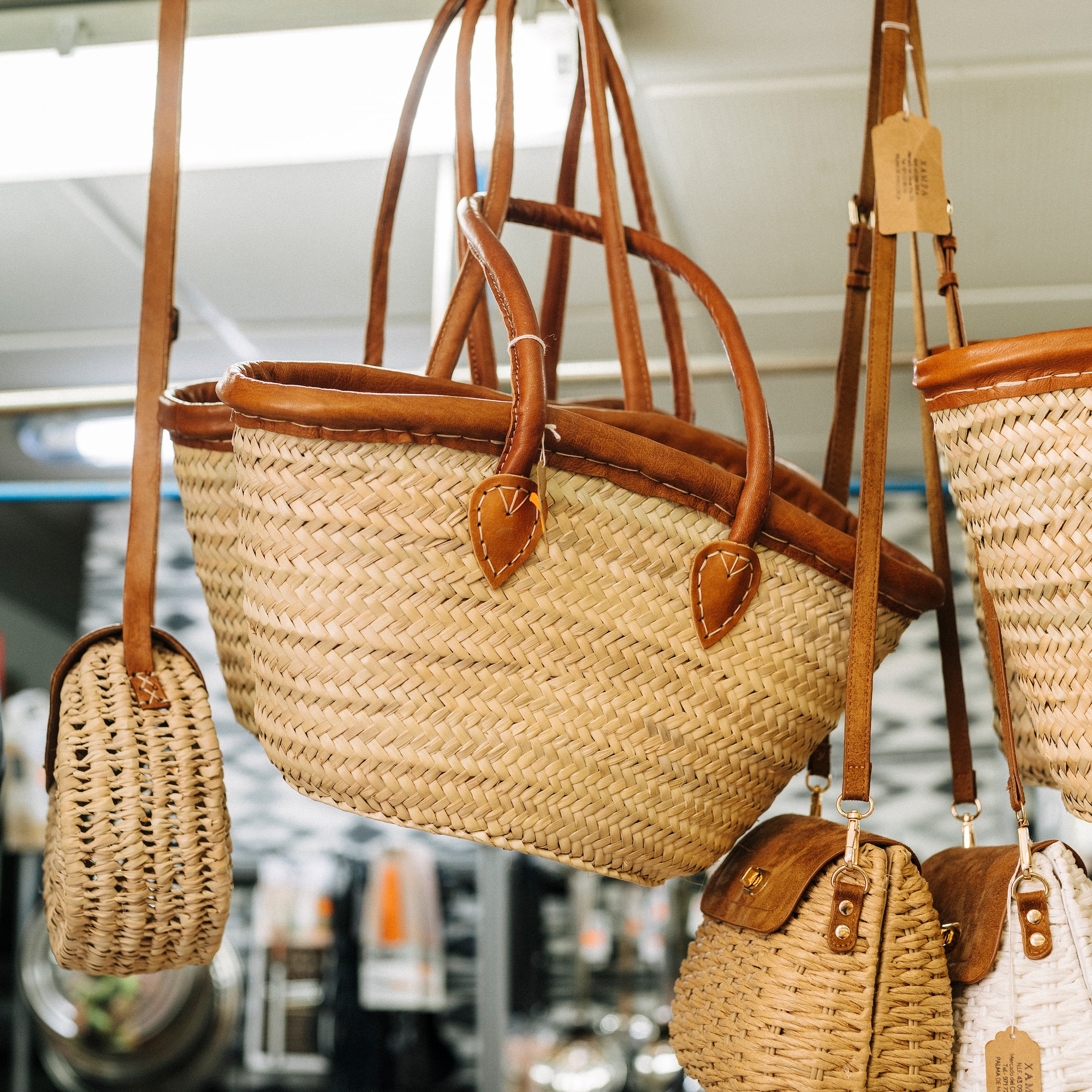 a group of woven bags from a ceiling