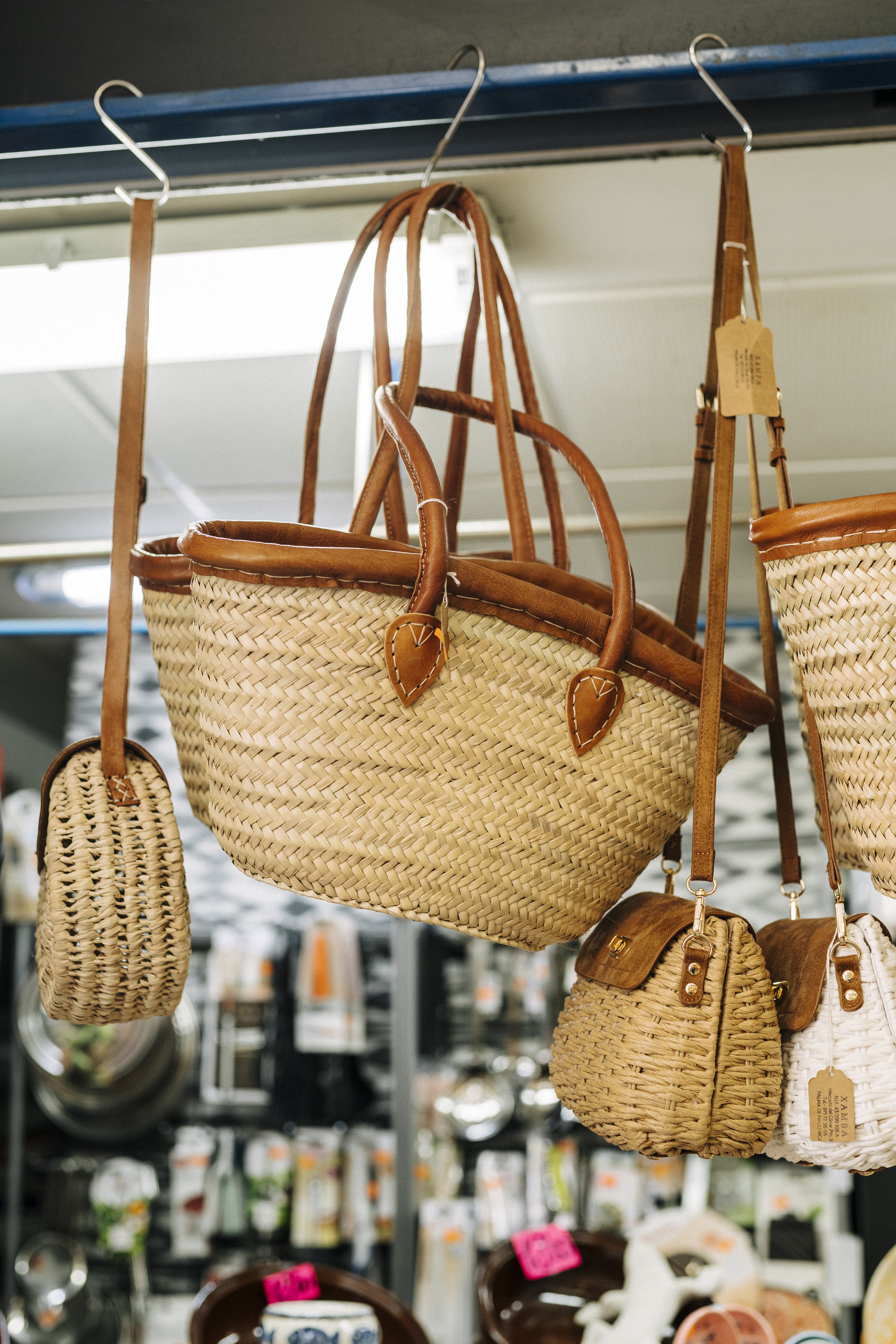 a group of woven bags from a ceiling