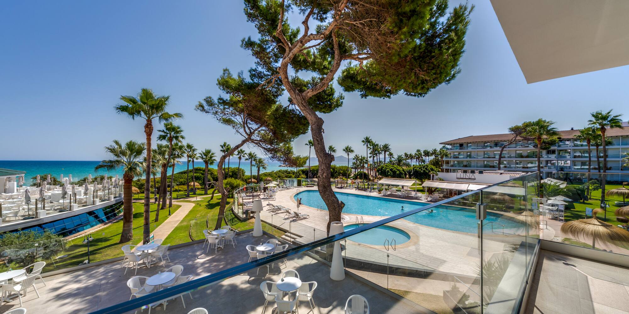a pool and tables outside a building