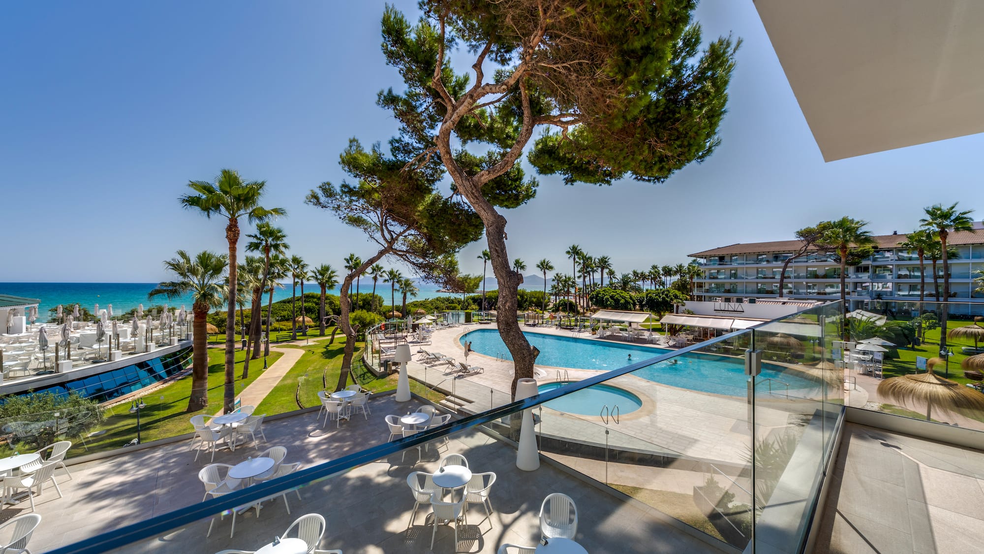 a pool and tables outside a building