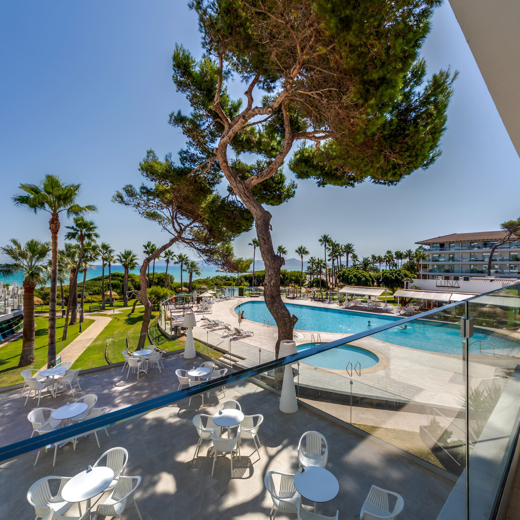 a pool and tables outside a building