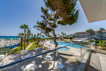 a pool and tables outside a building