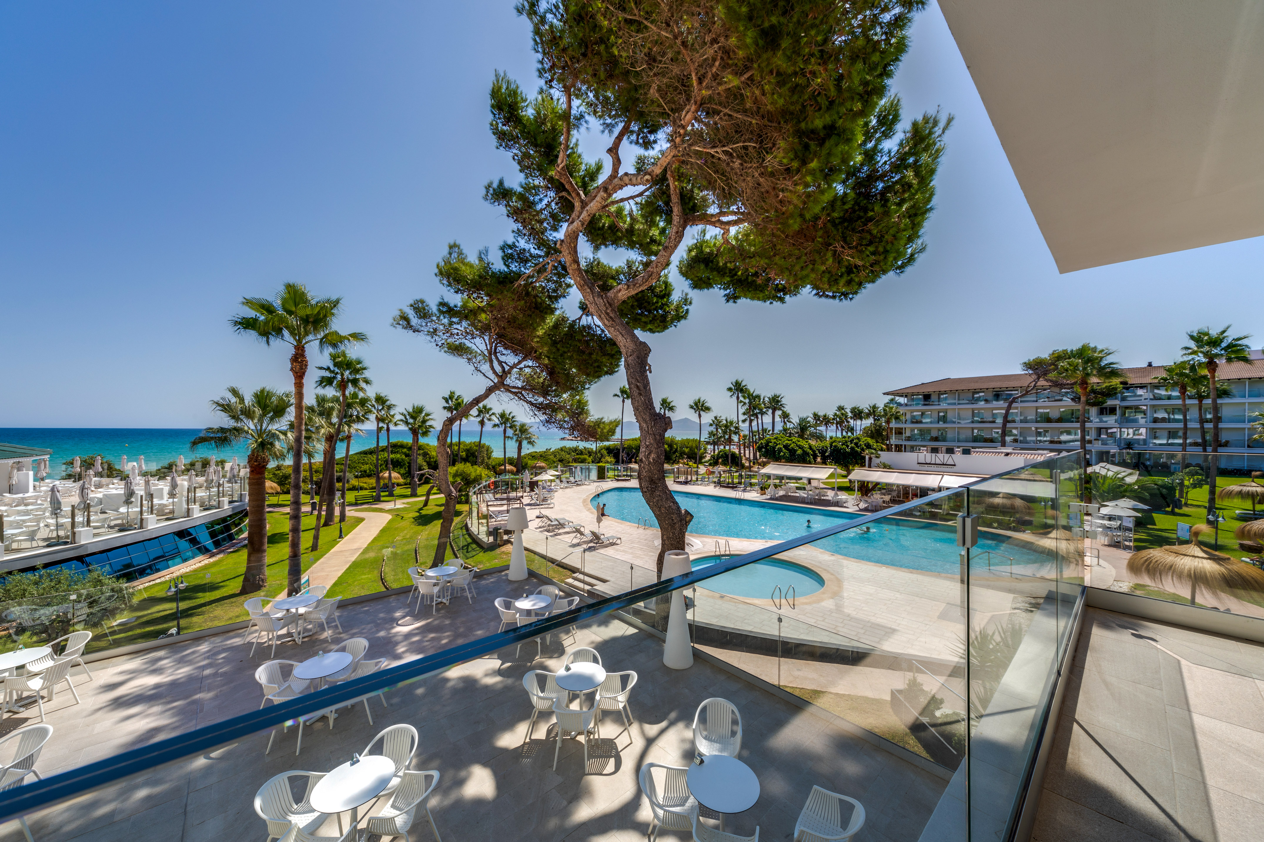 a pool and tables outside a building