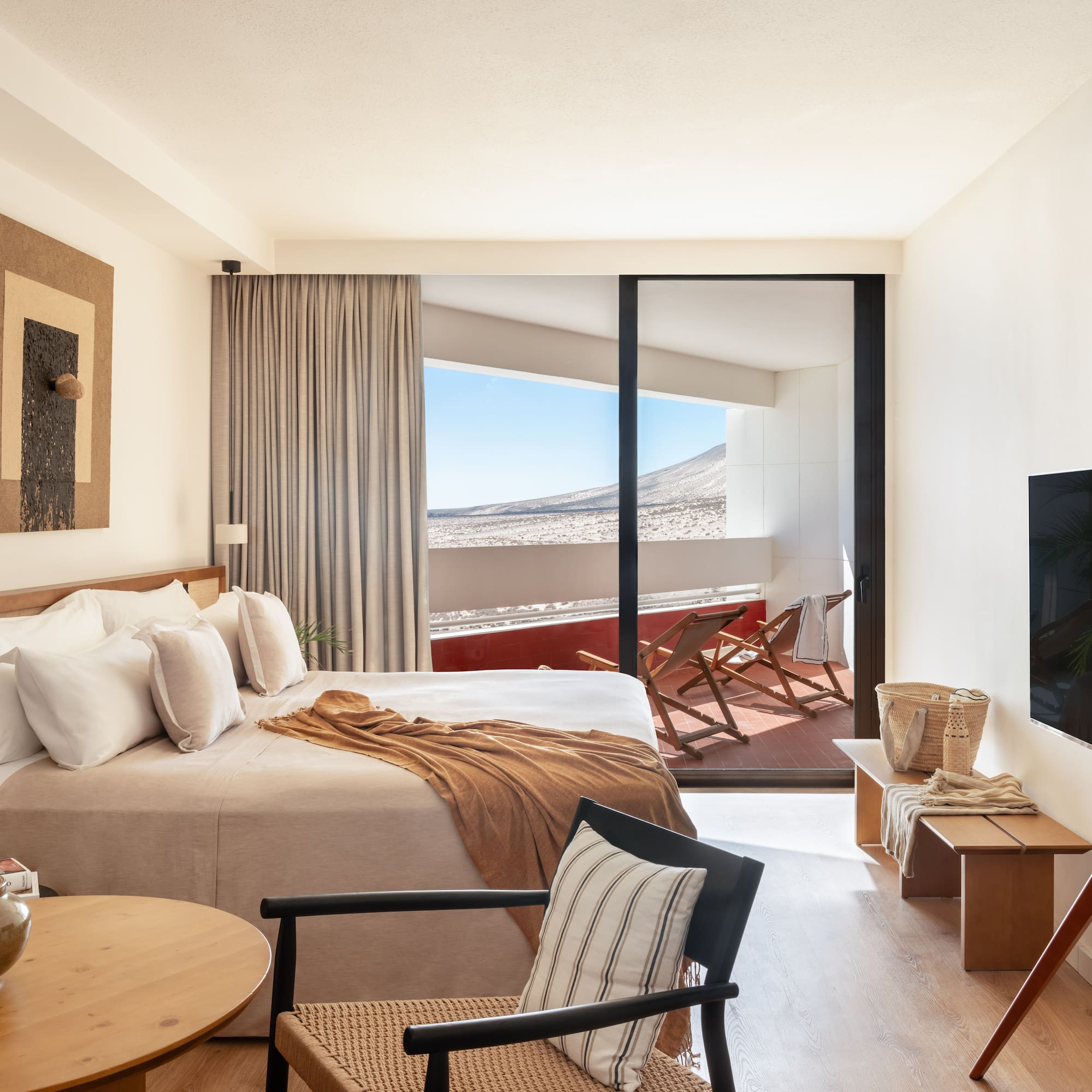 a bedroom with a bed and a television