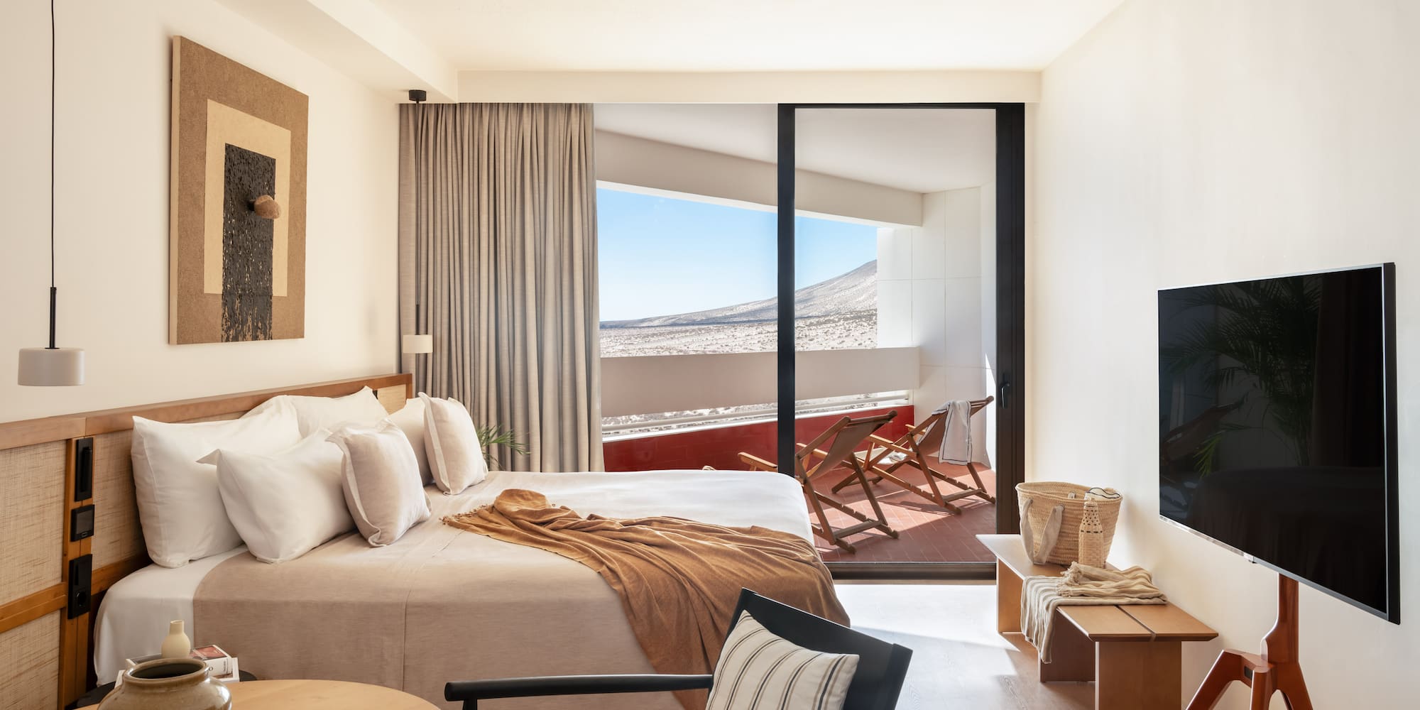 a bedroom with a bed and a television