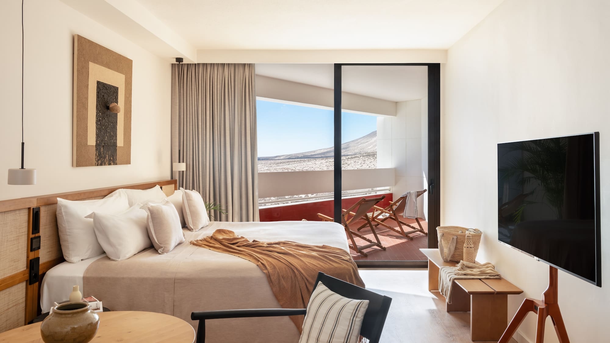 a bedroom with a bed and a television