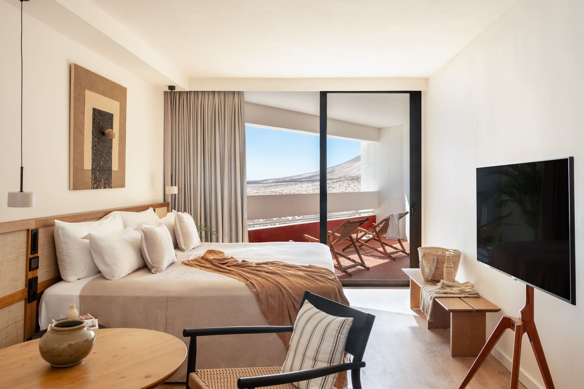 a bedroom with a bed and a television