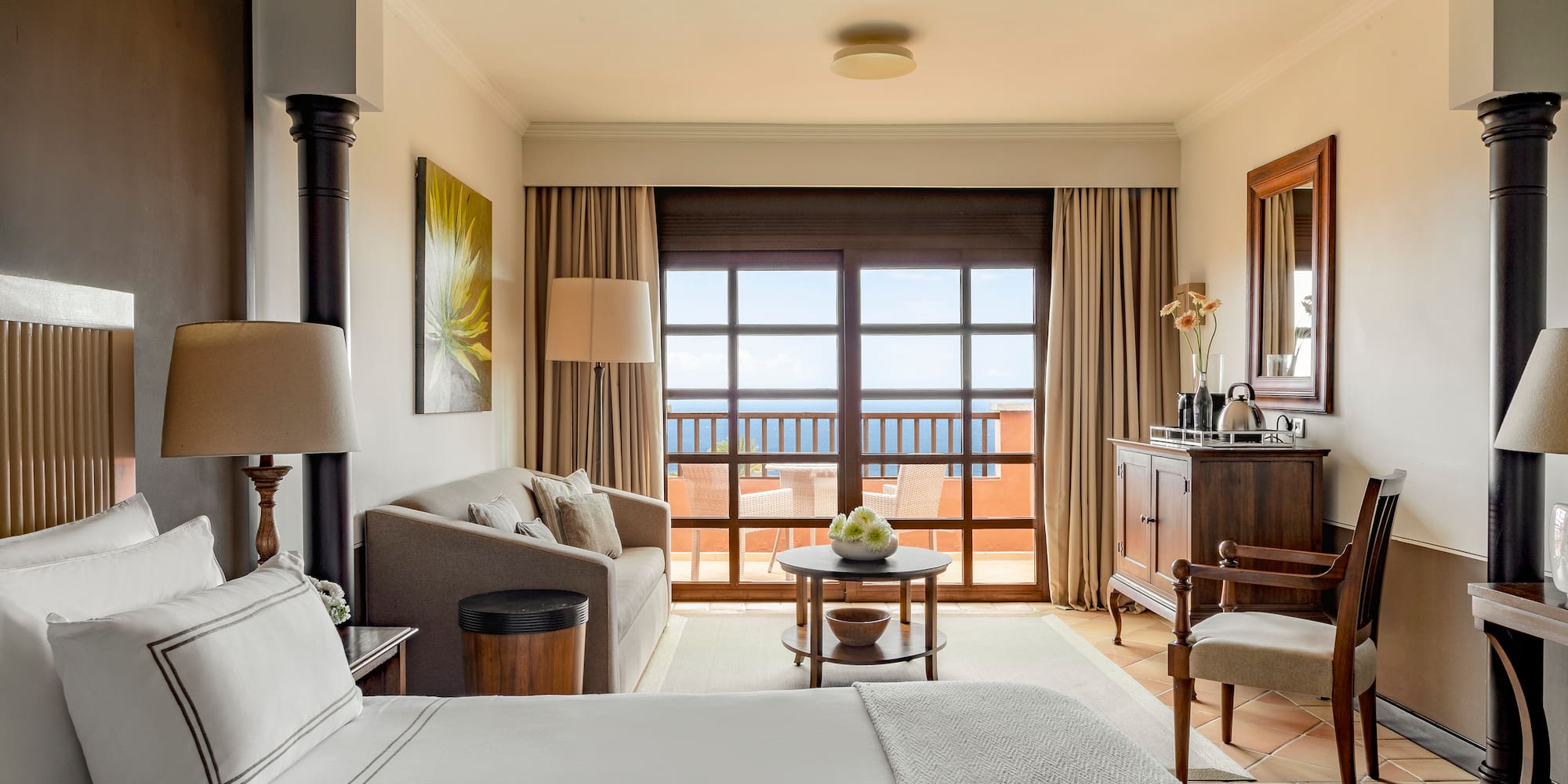 a room with a bed and a table and chairs