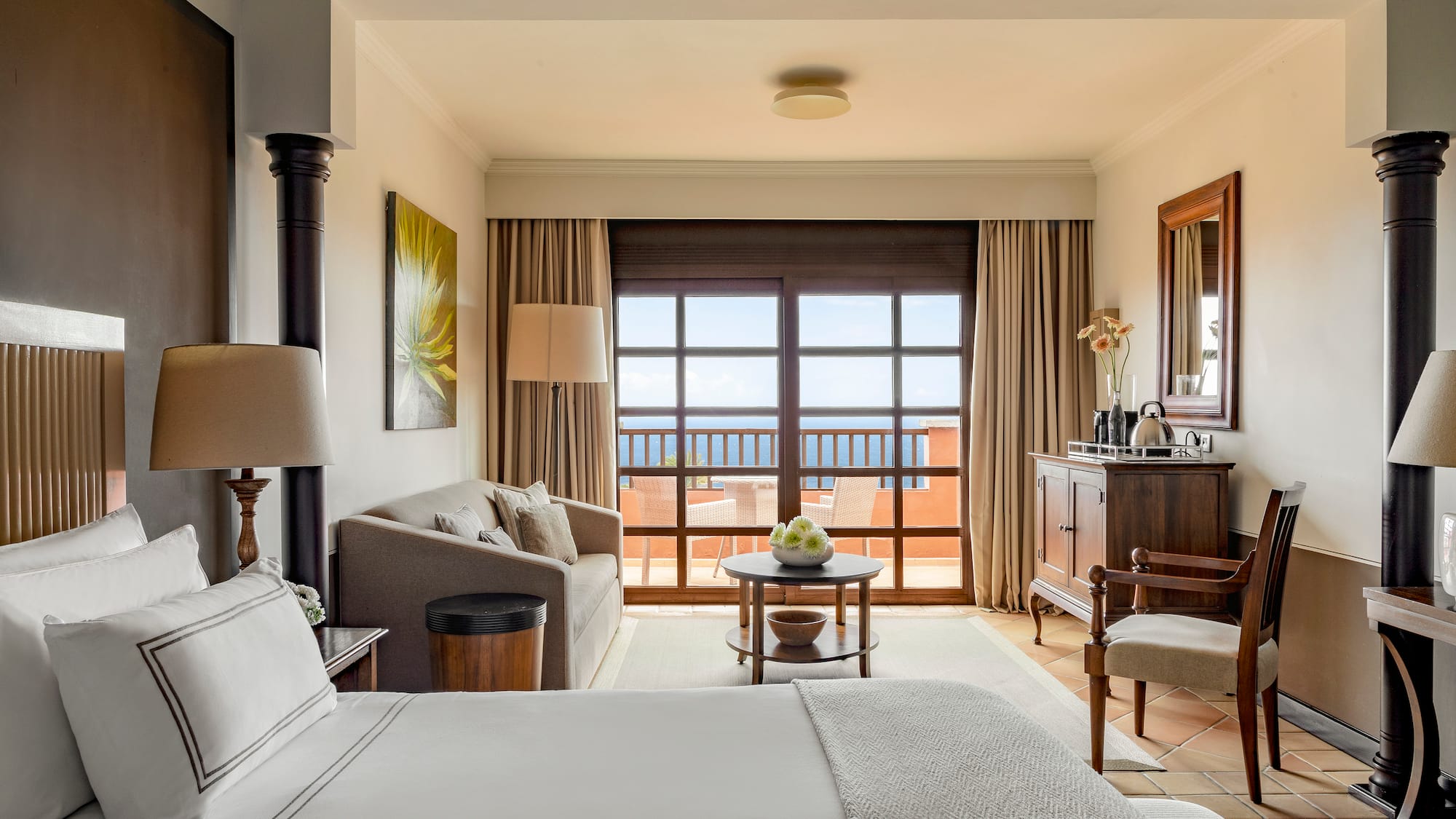 a room with a bed and a table and chairs