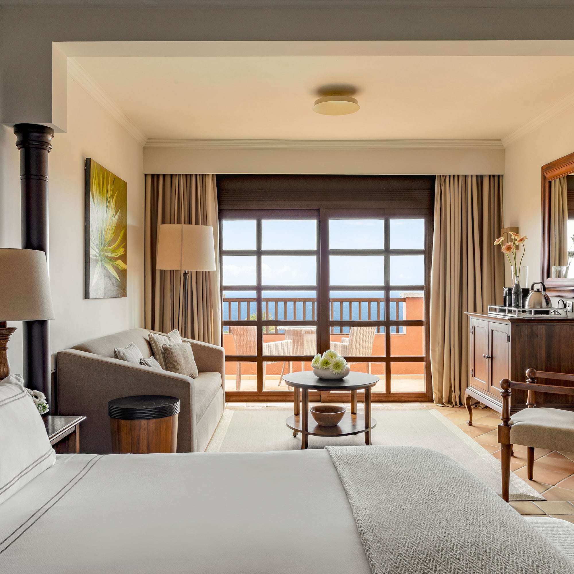 a room with a bed and a table and chairs