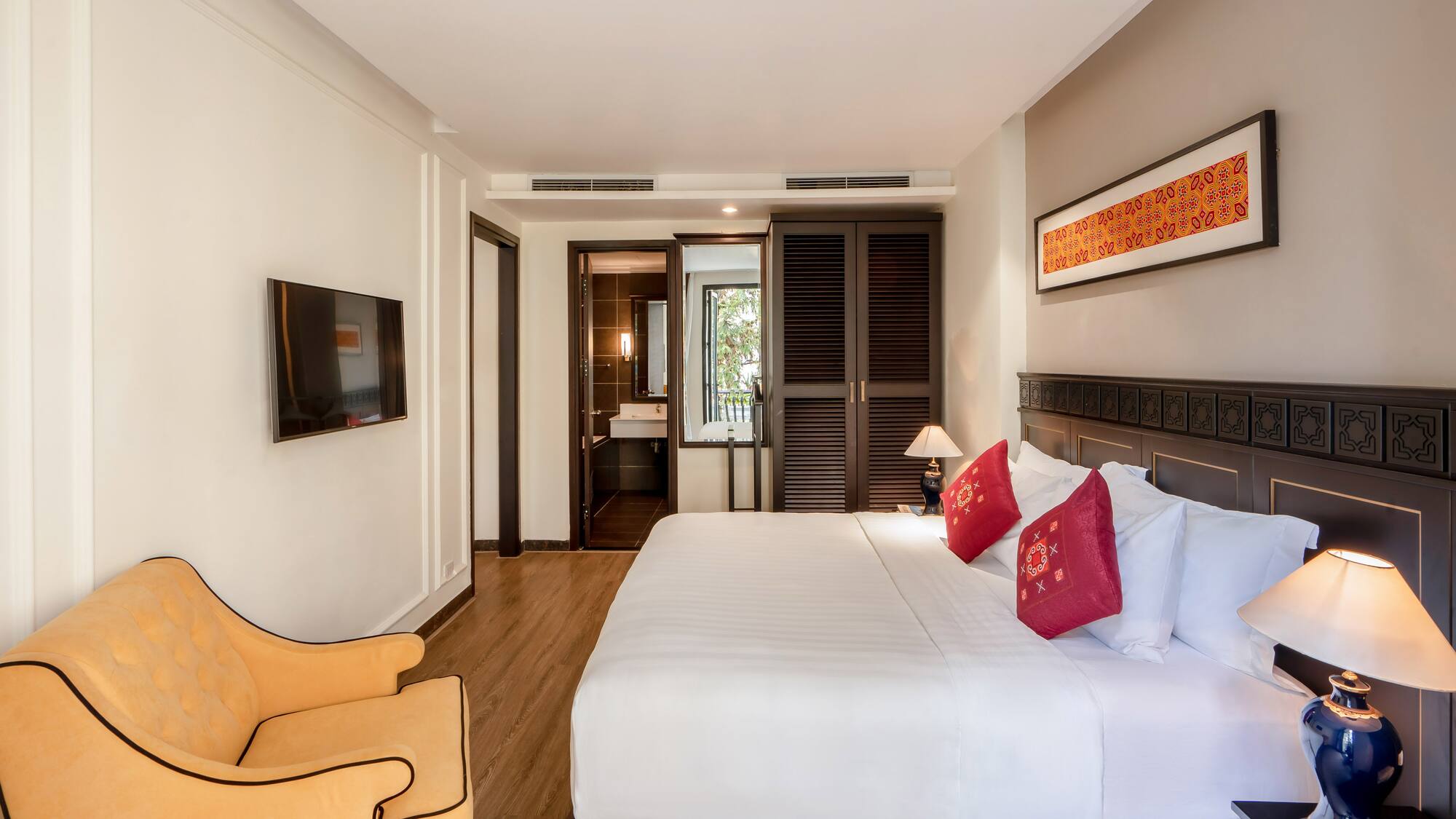 a bedroom with a bed and a chair