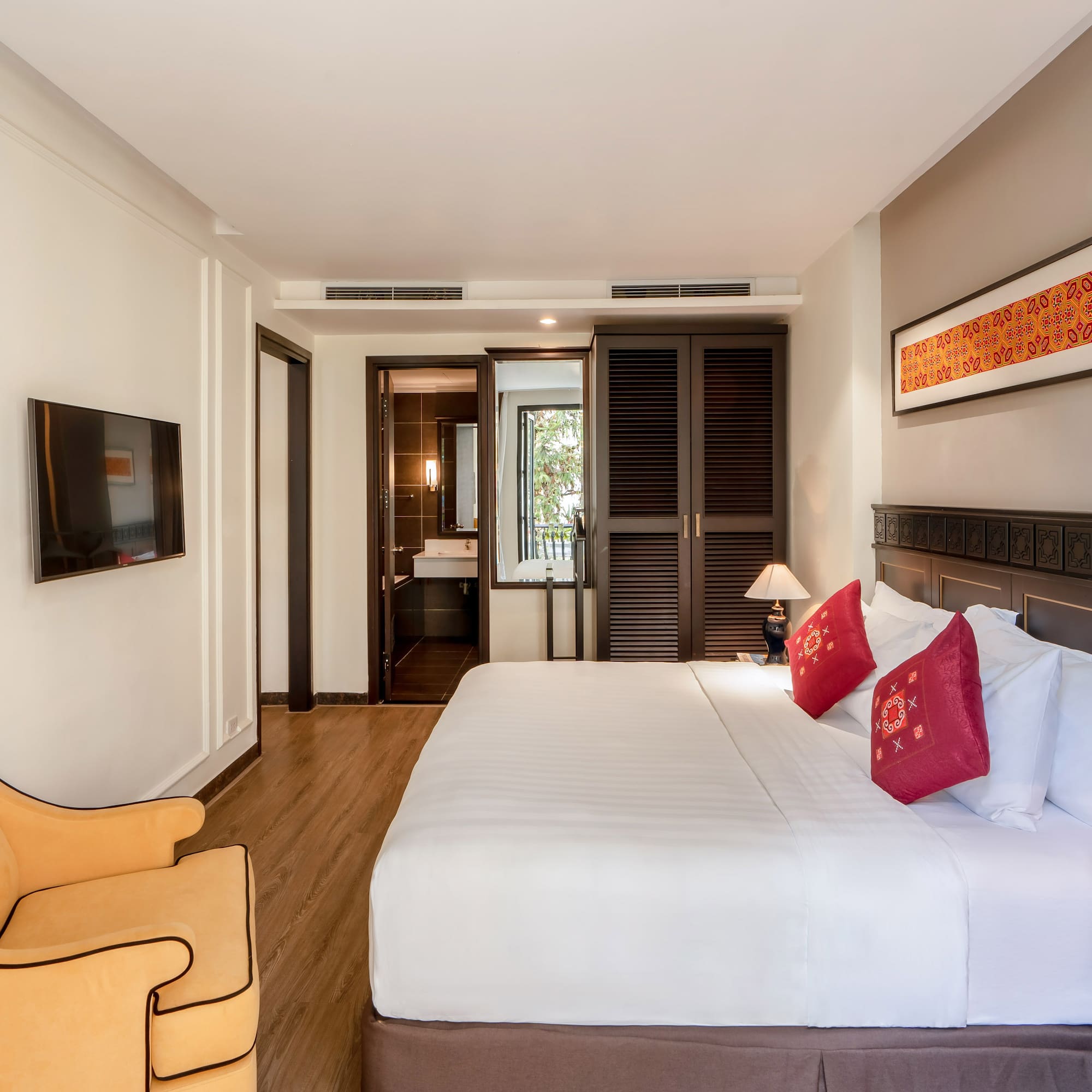 a bedroom with a bed and a chair