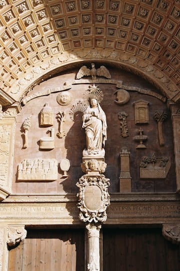 a statue of a woman in a crown on a wall