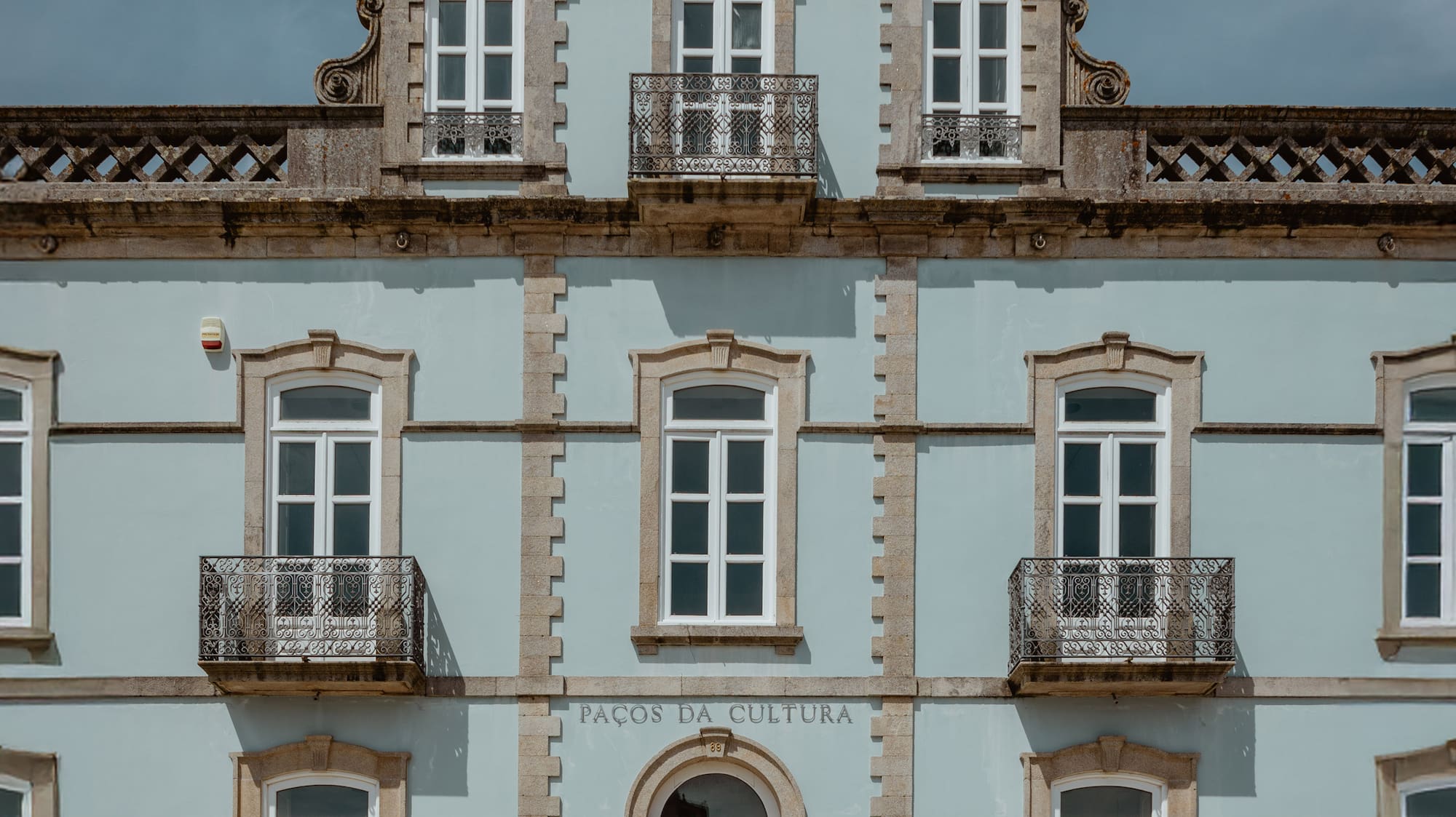 a building with a tower and a stone wall