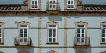 a building with a tower and a stone wall
