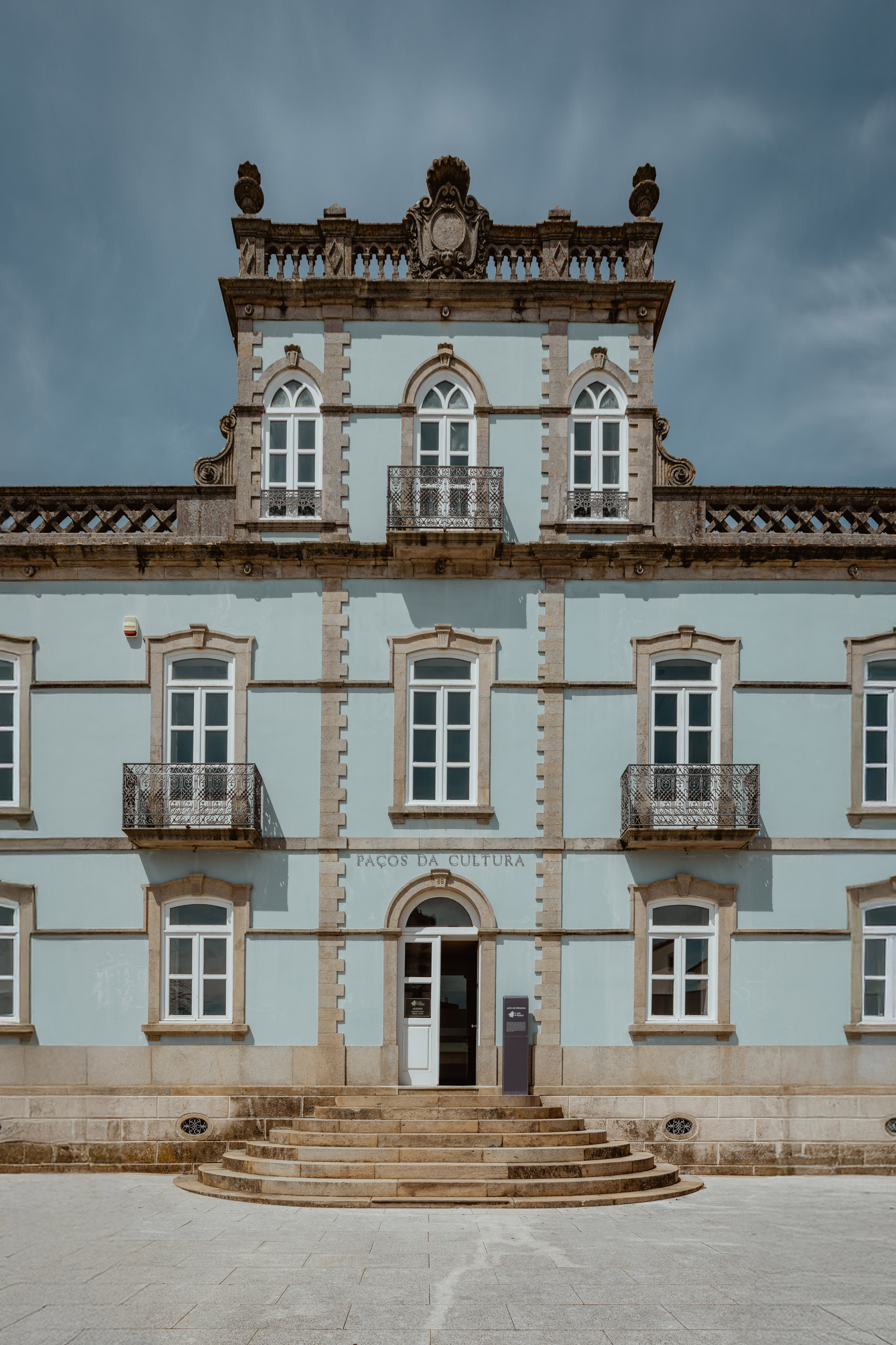 a building with a tower and a stone wall