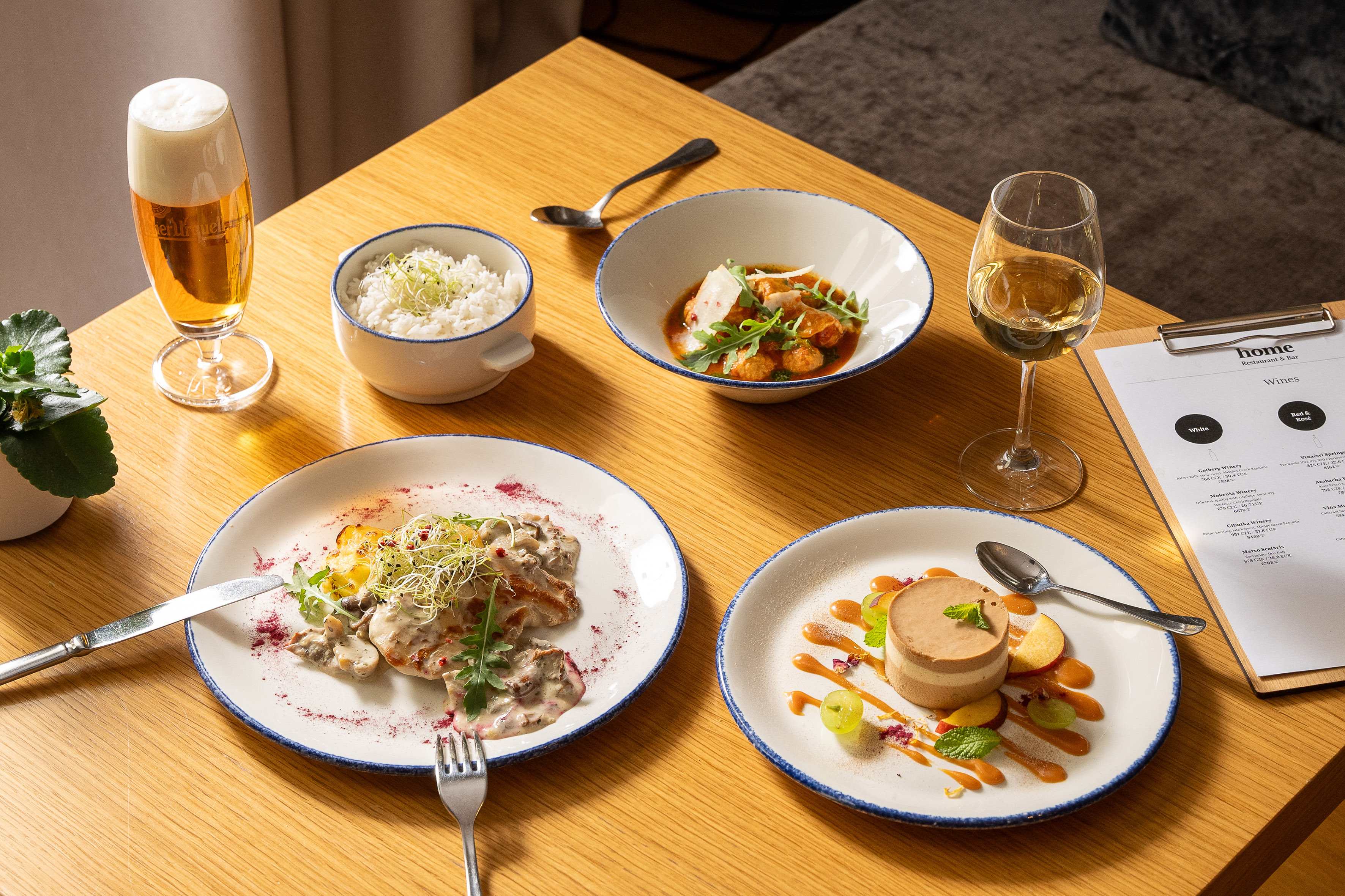 Gourmet dinner at Home Restaurant: chicken, rice, dessert, beer, white wine.