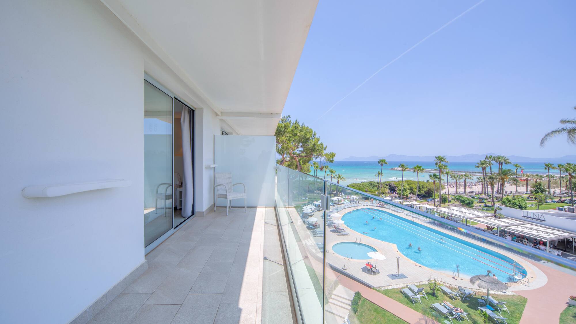 a balcony with a pool and a beach