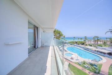 a balcony with a pool and a beach