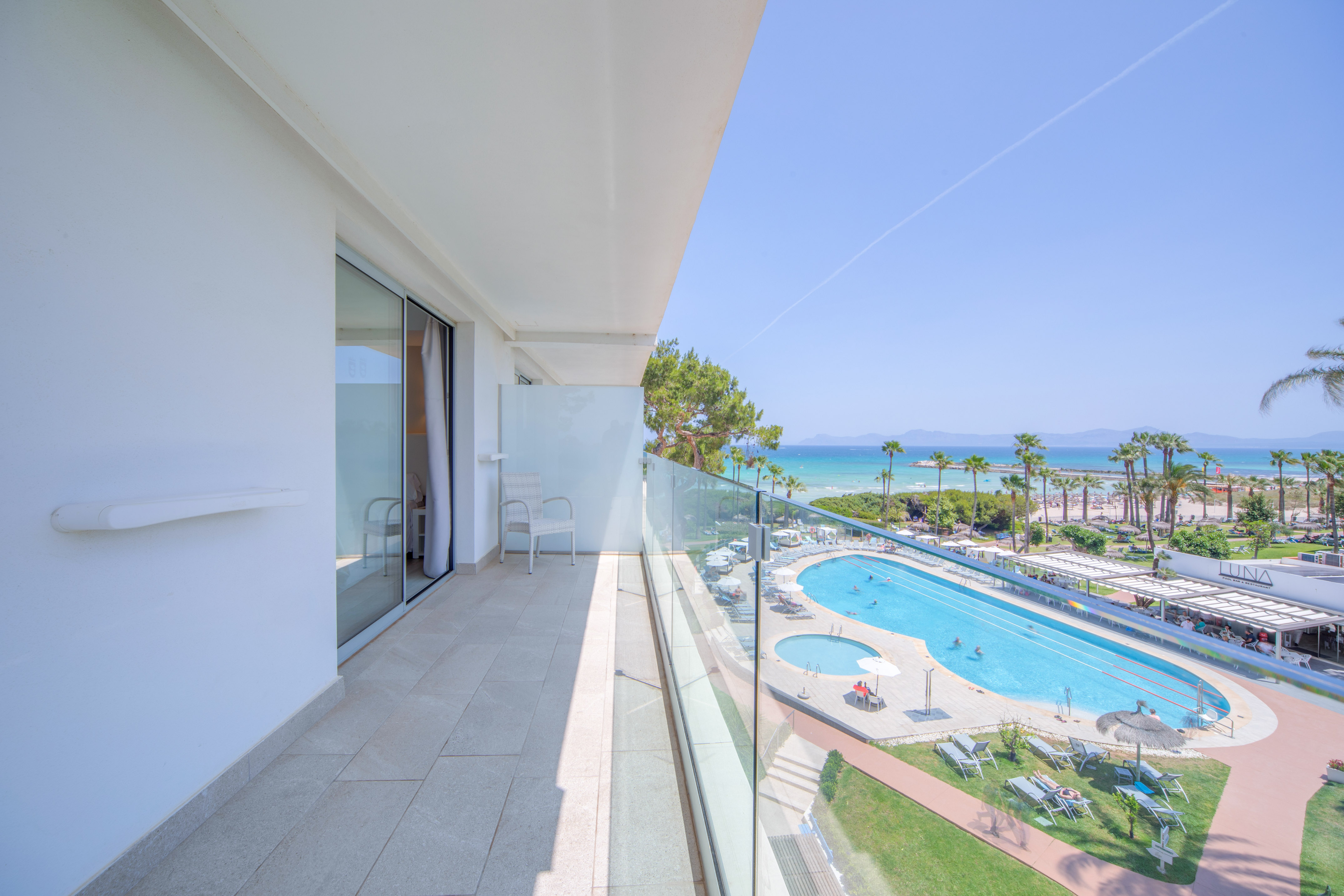 a balcony with a pool and a beach