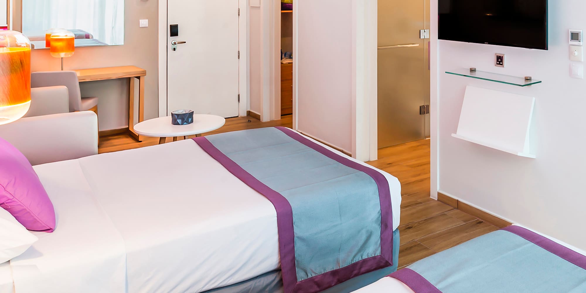 a room with two beds and a tv