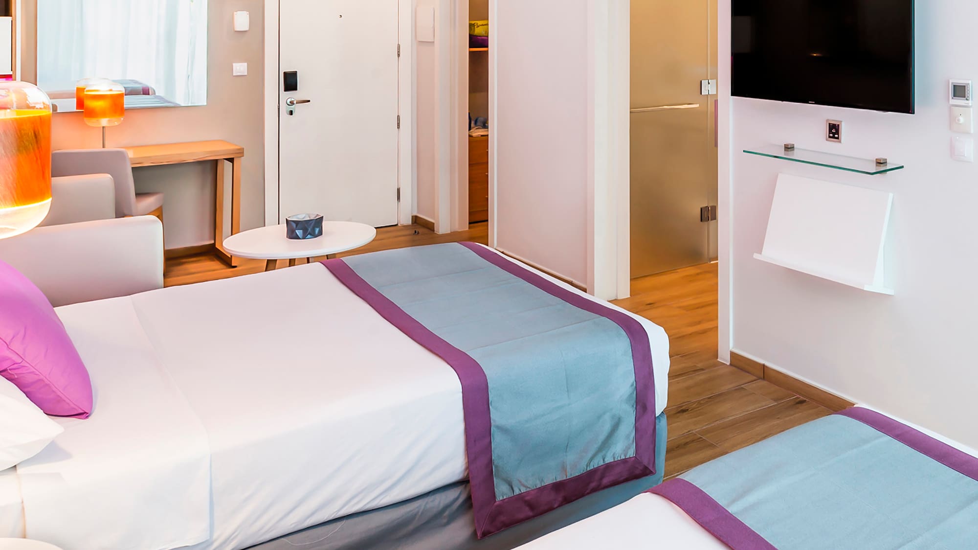 a room with two beds and a tv