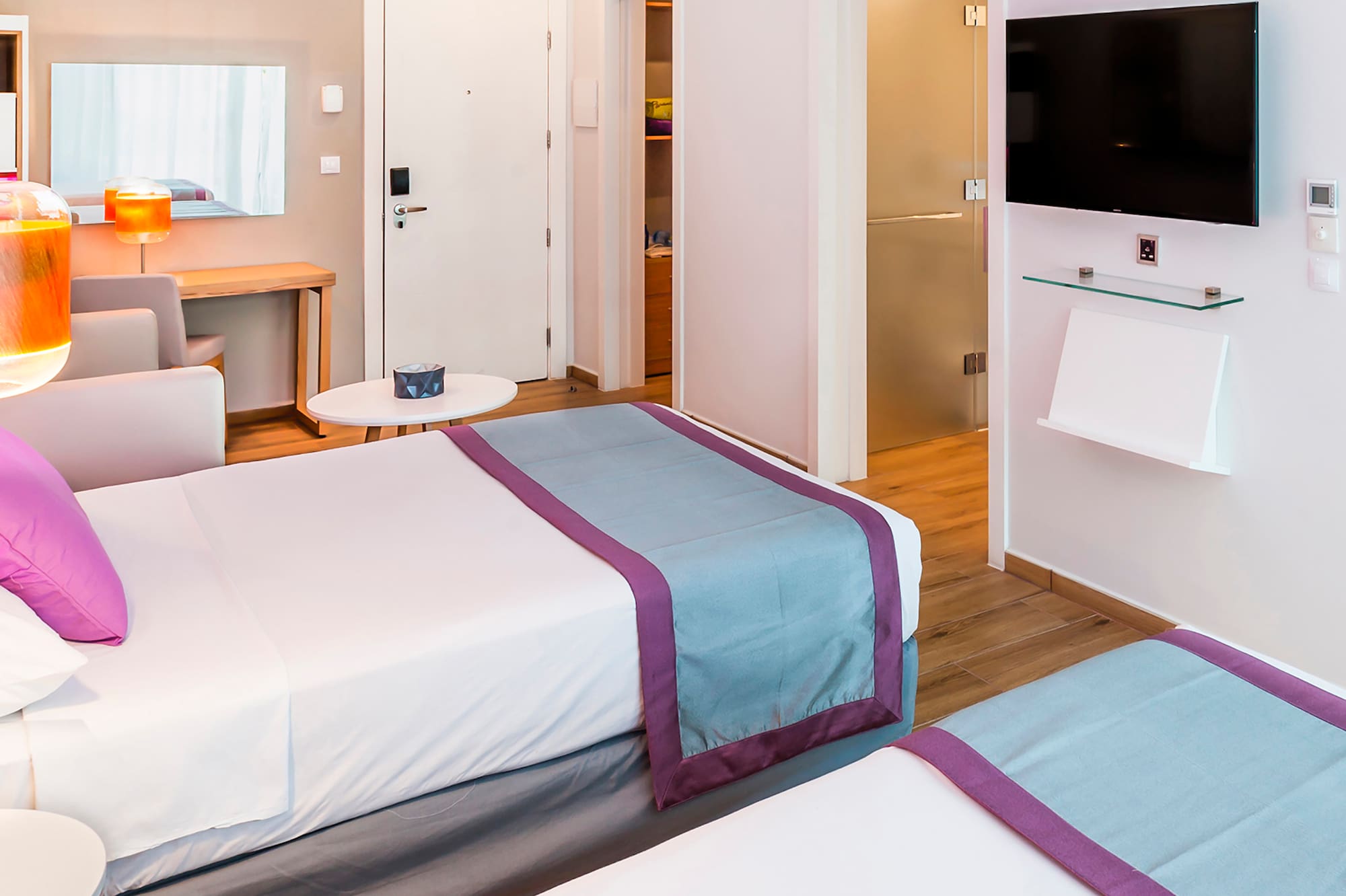 a room with two beds and a tv