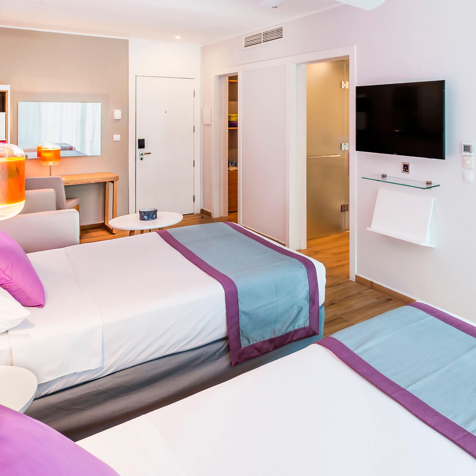 a room with two beds and a tv