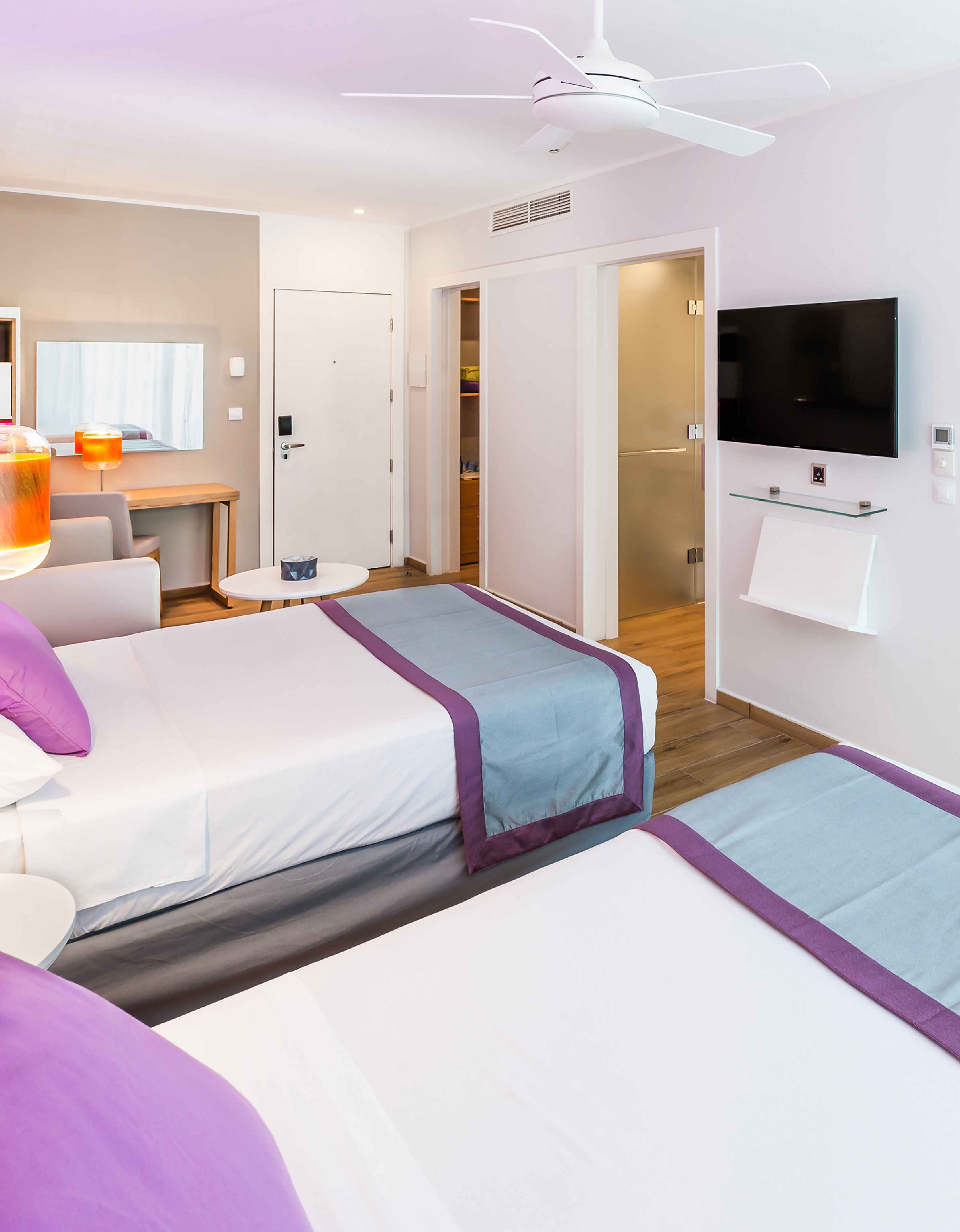 a room with two beds and a tv